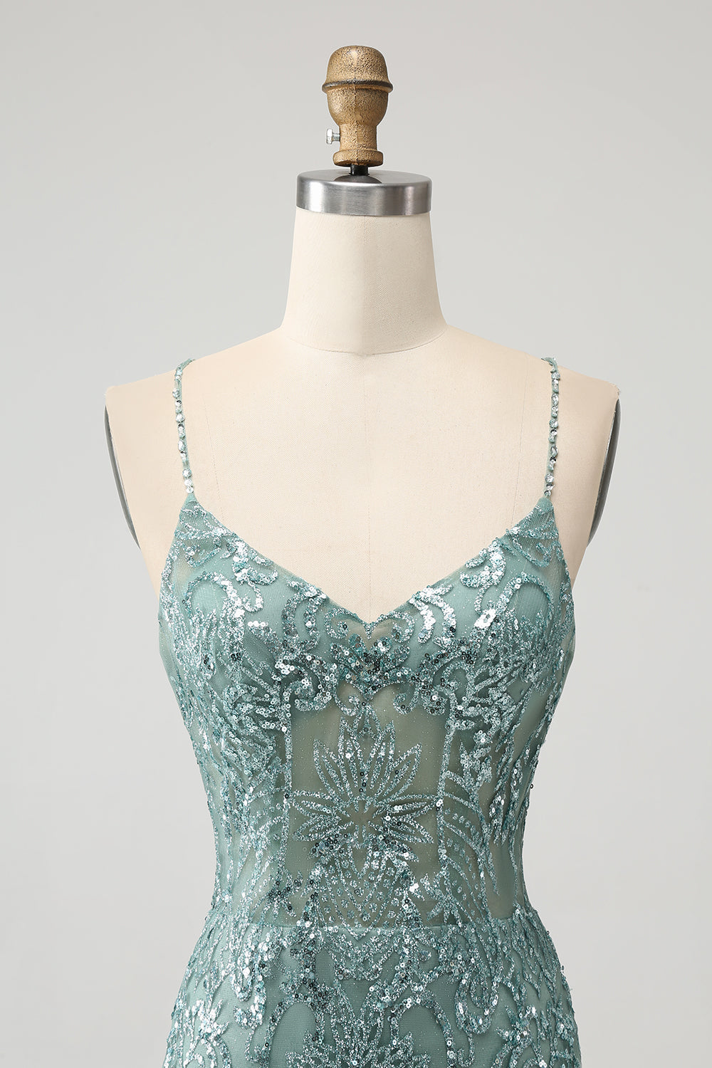 Robe de soirée courte moulante verte à dos nu et perles croisées dans le dos