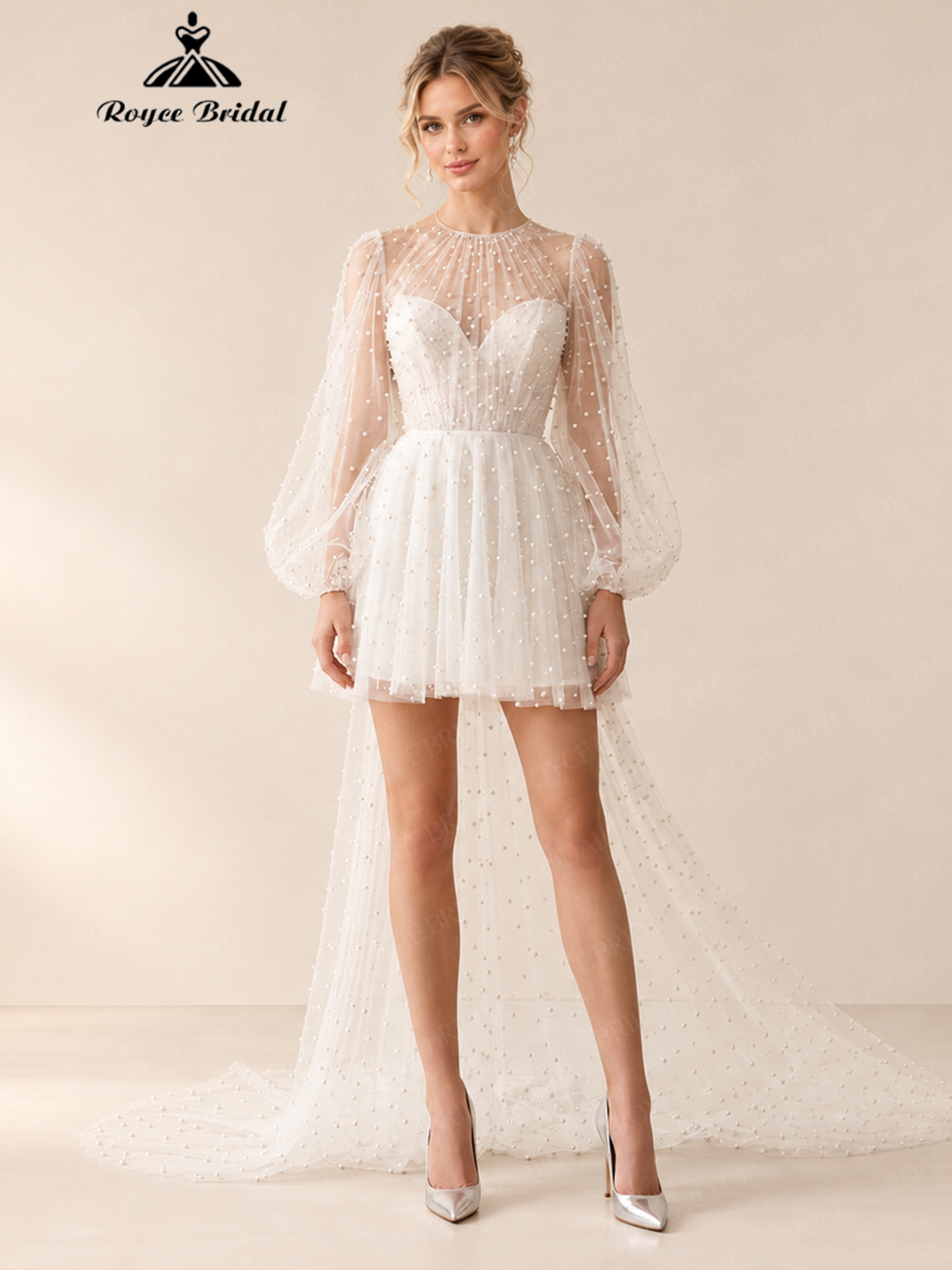 Front view of an ivory A-line mini wedding dress with sheer high neck, long sleeves, beaded fabric, and sheer train.