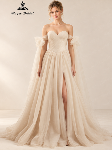 Front view of an ivory A-line wedding dress with draped off-the-shoulder straps, a pleated bodice, a front split, and a flowing skirt.