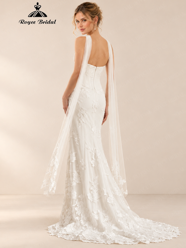 Back view of an ivory strapless mermaid wedding dress with floral applique, a zipper back, and a long train.